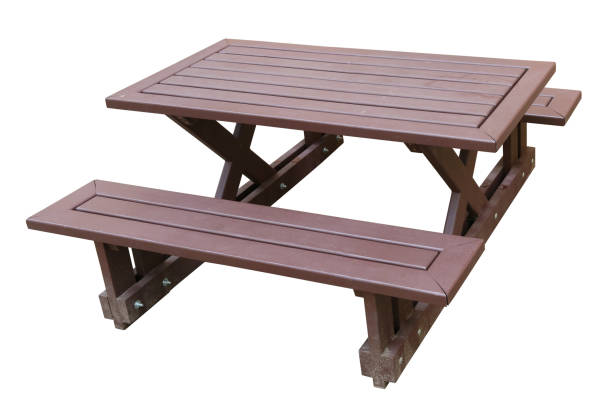 istock Standard wooden benches and a small restaurant table on a sandy sea beach. Isolated 902780654