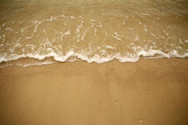 The surf waves onto the sand at Sailors Beach, Huskisson on December 20, 2017 in Jervis Bay, Australia.