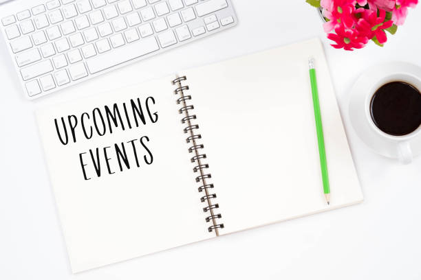 istock Concept Upcoming Events message on notebook, keyboard,with pencil and coffee cup. Top viwe of modern workplace. 902786594