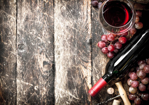 istock Wine background. Red wine with glasses with grapes. 902787218