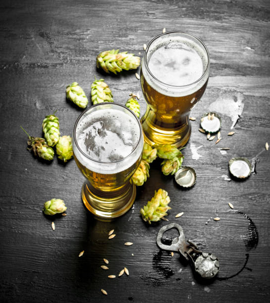 istock Glasses with beer and green hops. 902790350