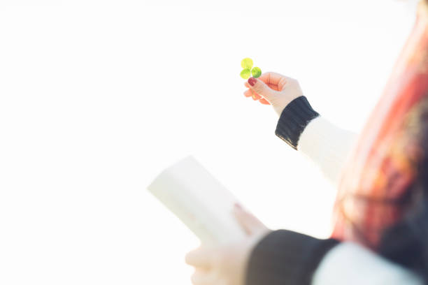 istock woman holding grass to the sky 902793490