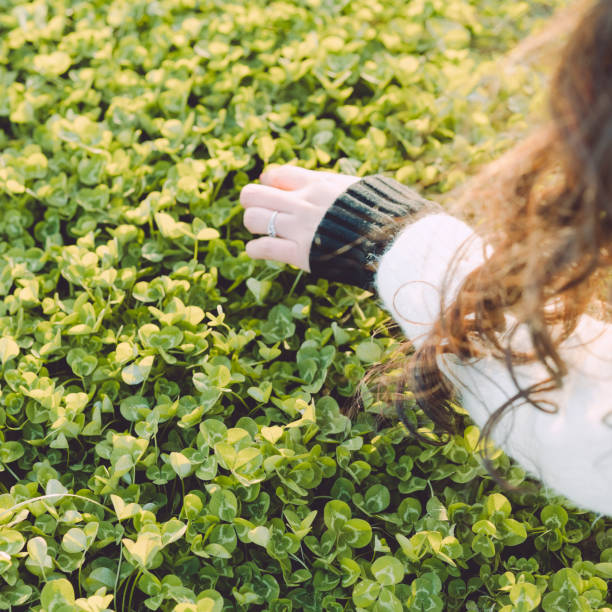 istock happy woman touching green grass 902793618
