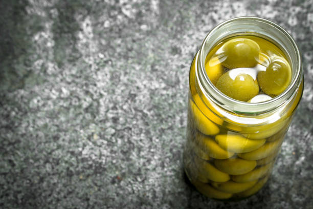 istock Pickled olives in glass jar. 902794116