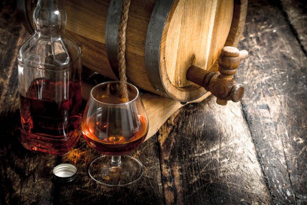 istock Cognac in a barrel with a glass. 902794370