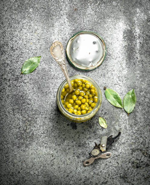 istock Marinated green peas in glass jar. 902794442