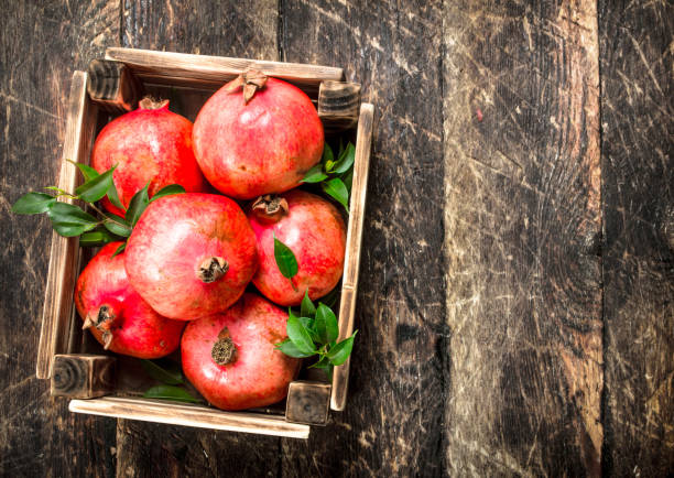 istock Fresh pomegranates in an old box. 902794906