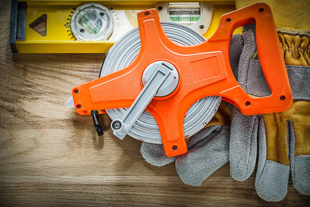 istock Construction level protective gloves measuring tape on wooden bo 902794922
