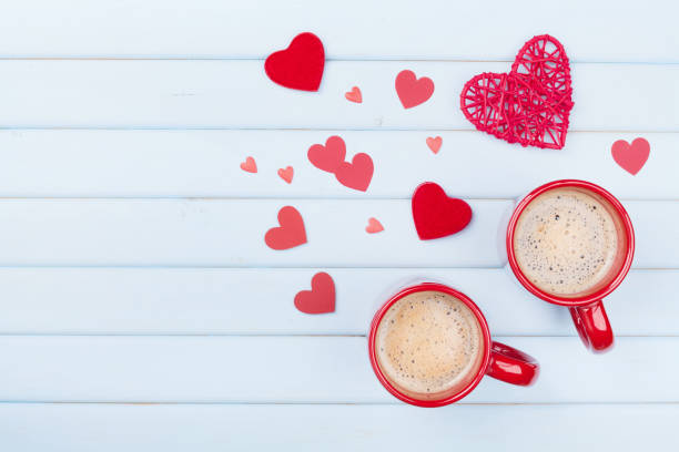 istock Two cup of coffee and mixed hearts on pastel blue table top view. Morning breakfast for Valentines day. Love concept. 902799886