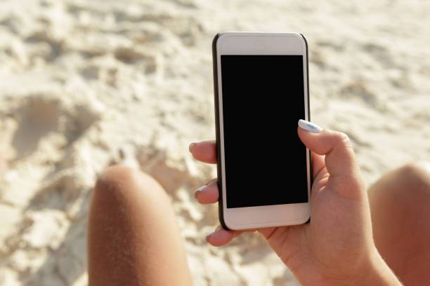 istock Female hand holding smartphone with blank screen close up 902801032