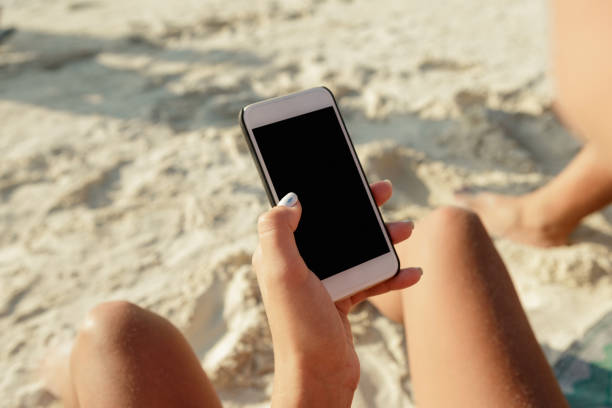istock Female hand holding smartphone with blank screen close up 902801036