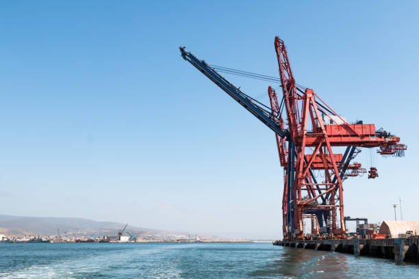 Ensenada, Mexico - May 3, 2017:  A super post-Panamax crane in between two Panamax cranes in the Port of Ensenada, the second busiest port in Mexico.
