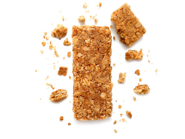 Cereal bars or flapjacks made from rolled oats Cereal bars or flapjacks made from rolled oats with crumbs isolated on white background. Top view. crumb photos stock pictures, royalty-free photos & images
