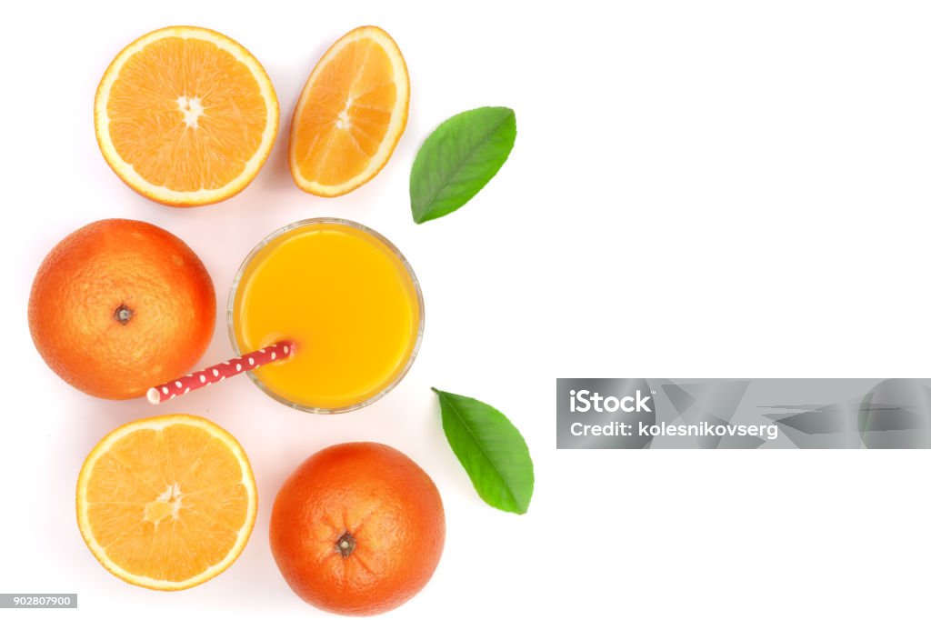 orange juice glass with slices of citrus and leaves isolated on white background with copy space for your text, top view orange juice glass with slices of citrus and green leaves isolated on white background with copy space for your text, top view. Flat lay pattern Drinking Glass Stock Photo