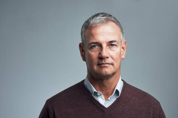 Life is as serious as you make it Studio shot of a handsome mature man against a grey background smart casual stock pictures, royalty-free photos & images