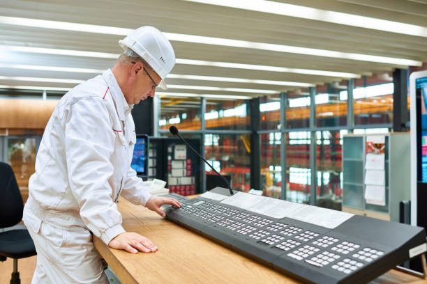istock Manufacturing operator making announcement at factory 902811550