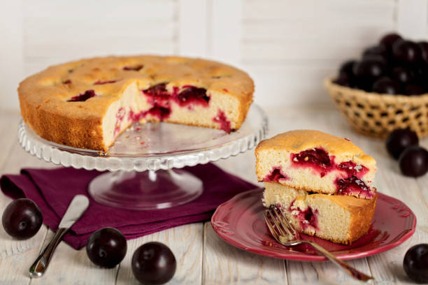 istock Homemade plum cake on a glass stand. 902811664