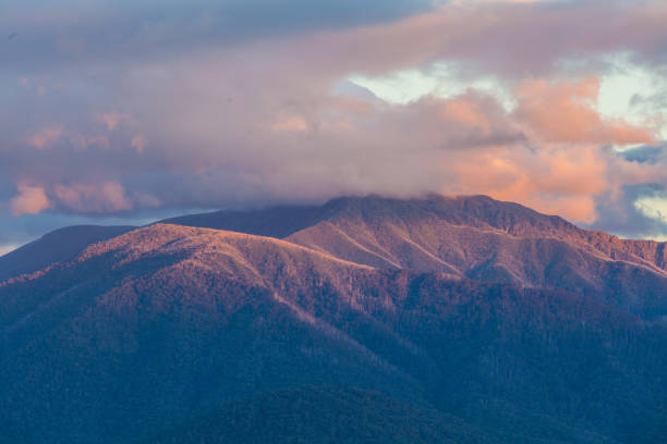 istock Australian Alps in orange sunset light and low clouds 902811902