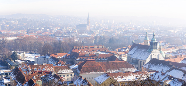 A panoramic view of the old town from the Grazer Schlossberg  in  frosty winter morning, Graz, Austria. In the background Church of the Sacred Heart of Jesus