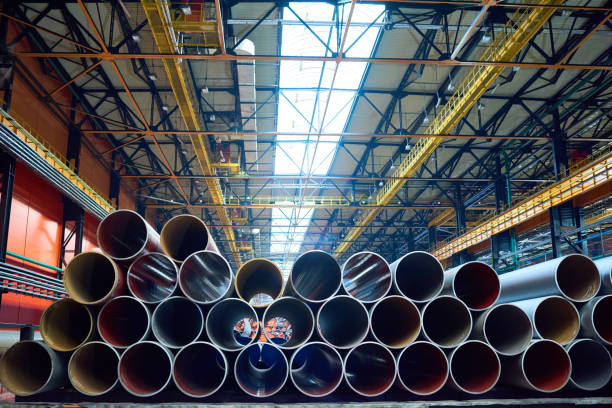 Heap of pipes and tubes of equal size at factory storage prepared for customers