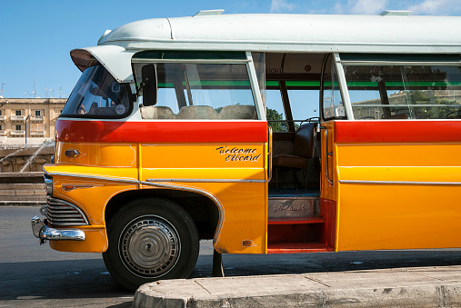 vintage orange british bedford buses on street of la valletta old town malta