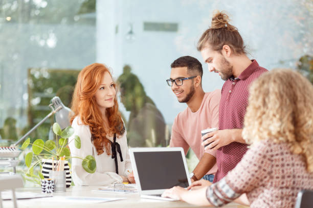 Workers at advertising agency Mixed race workers having a brainstorm at the advertising agency office travel agency stock pictures, royalty-free photos & images