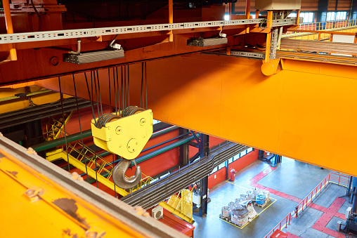 Overhead crane used to move materials across the bridge beam at factory