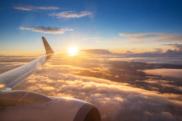 Sunset sky on airplane window over Copenhagen, Denmark in Friday Sunset sky on airplane window over Copenhagen, Denmark, Scandinavia, Europe in Friday evening flight for relax in holiday planes flying overhead stock pictures, royalty-free photos & images