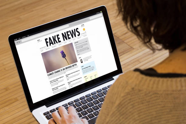 istock woman computer fake news 902819634