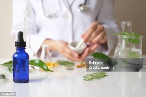 The Scientist Or Doctor Make Herbal Medicine From Herb In The Laboratory On The Table Alternative Treatment Show Hand And Stethoscope With The Bottle Container Stock Photo - Download Image Now