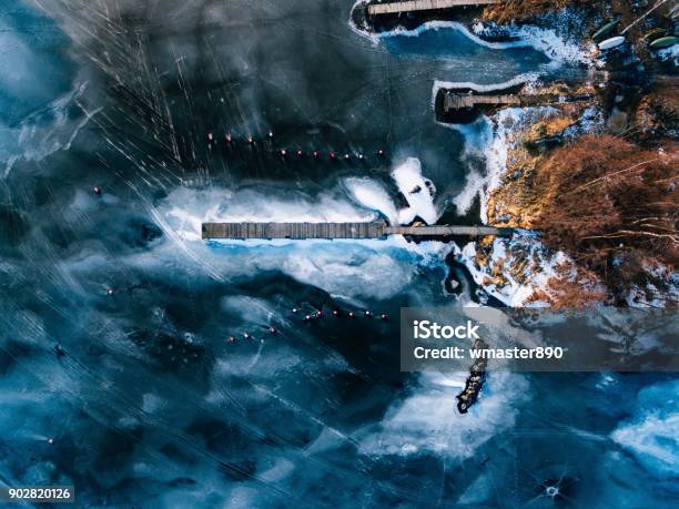 Aerial View Of The Winter Frozen Lake With Wooden Piers Captured With A Drone In Finland Stock Photo - Download Image Now