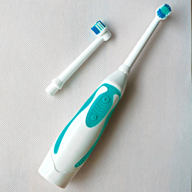 istock Electronic toothbrush with toothbrush heads white color background 902826746