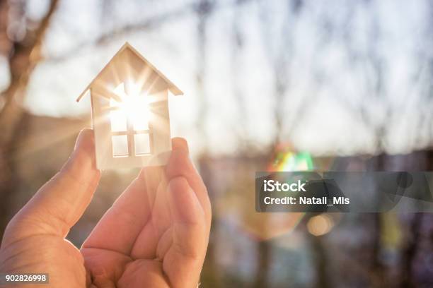 House In Hand In The Rays Of The Sun Stock Photo - Download Image Now - House, Real Estate, Vitality