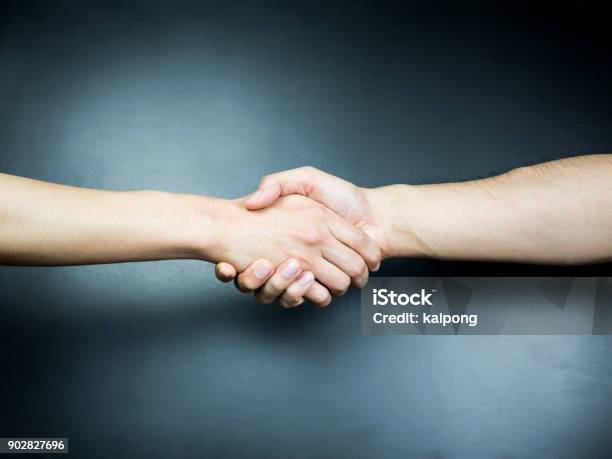 Two Handed Handshake On Black Background Stock Photo - Download Image Now - Handshake, Close-up, Cut Out