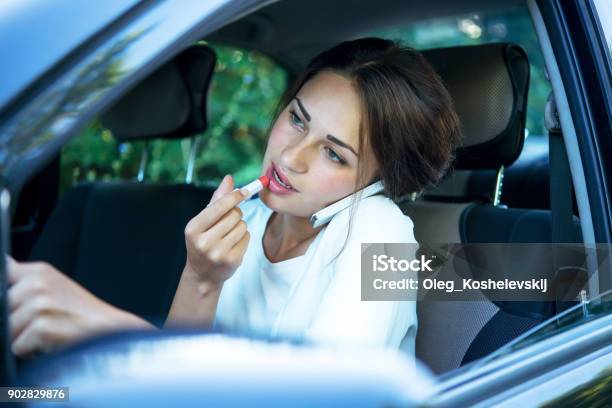 Busy Girl With Lipstick And Phone While Driving Stock Photo - Download Image Now - Driving, Distracted, Driver - Occupation