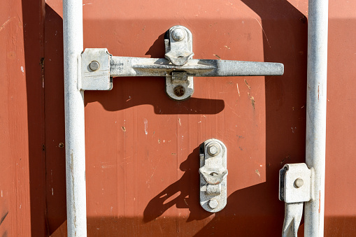 Closeup view of a worn intermodal container door locking system.