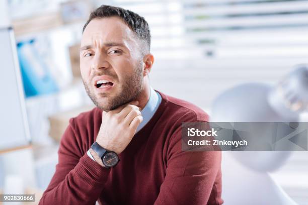Emotional Worker Touching His Neck And Having A Sore Throat Stock Photo - Download Image Now