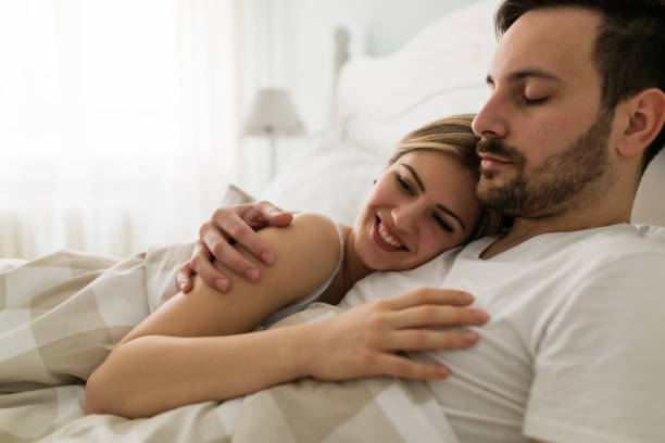 istock Young attractive couple having romantic time in bed 902830668
