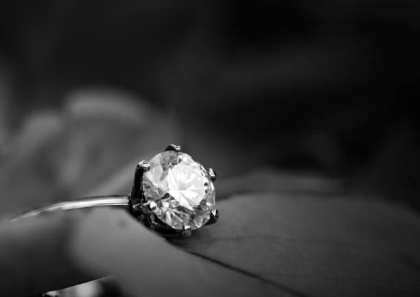 Golden diamond ring Wedding golden diamond ring on rose petals. Black and white diamond ring photos stock pictures, royalty-free photos & images