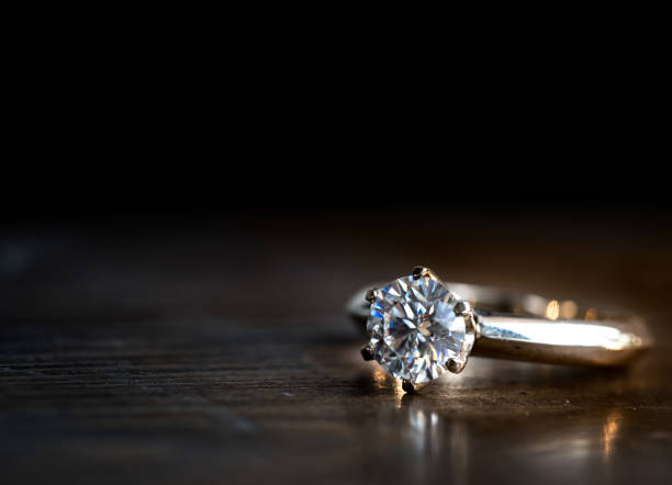 Wedding diamond ring golden diamond ring on the wooden table diamond ring stock pictures, royalty-free photos & images