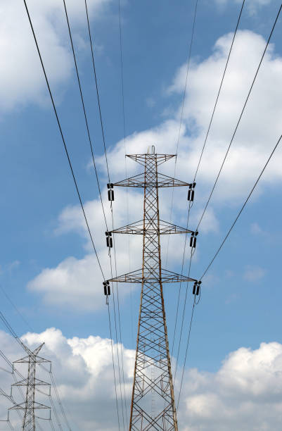 istock high voltage pole and voltage power line on blue sky background. 902831816