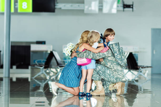 istock family hugging father at airport 902831852