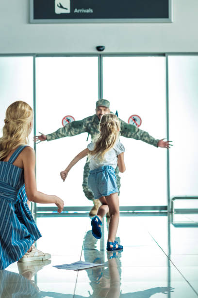 istock happy child running to father in military uniform 902832206