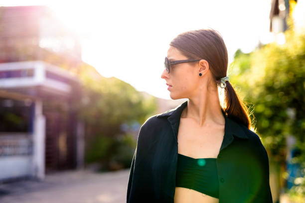 istock Beautiful Young Woman With Cool Attitude Outdoors Wearing Sunglasses 902835514