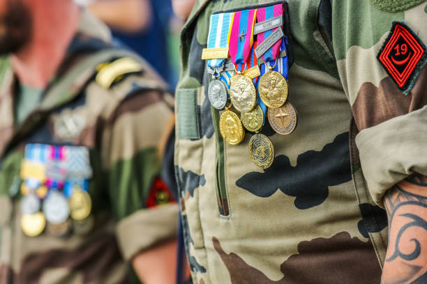 Close-up of two French soldiers carrying medals and decorations for services rendered to the homeland. Paris, France - July 14 2014: Photo taken during the parade on July 14th during the National Day. Close portrait of two French military officers bearing medals and decorations for services rendered to their homeland. chest tattoos for men designs stock pictures, royalty-free photos & images