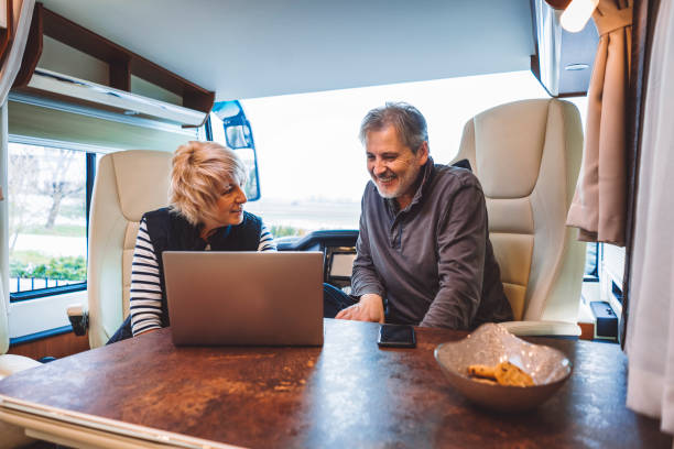 istock Couple smiling in their luxurious mini van 902838784