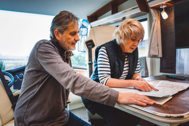 istock Mature couple planning the day inside of a camper 902839002