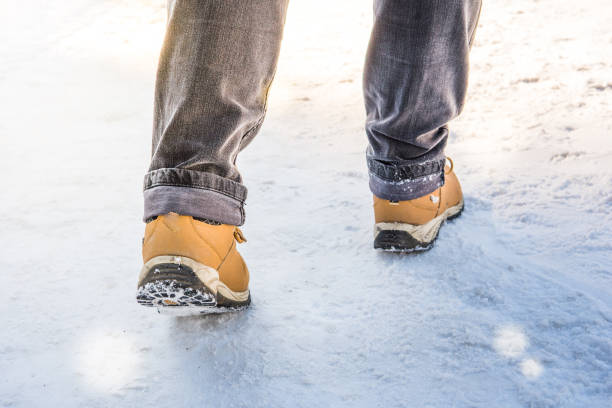 istock Feet in boots walking on the snow 902839334