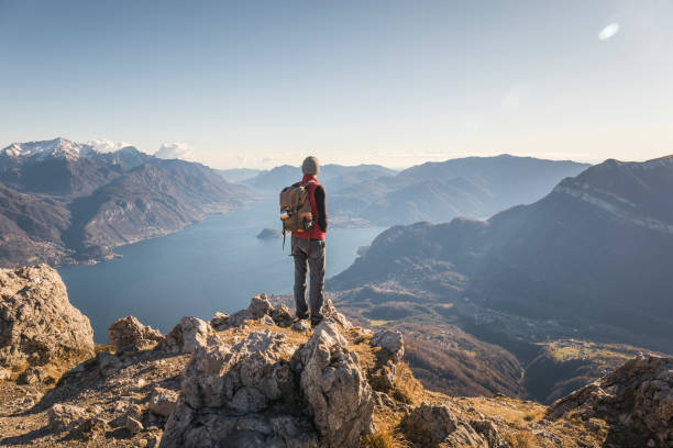 Hiker alone on top of the mountain Hiking mountain italian lake district photos stock pictures, royalty-free photos & images