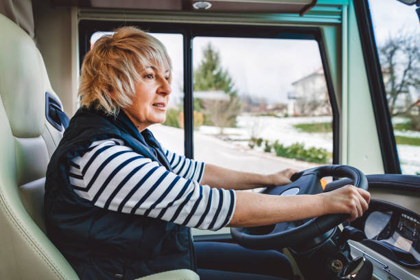 istock Happy and focused woman driving her caravan 902845792